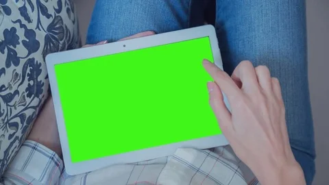 Beautiful Girl Using Tablet PC with Green Screen Laying on Sofa at Home 45 Stock Footage 74937989