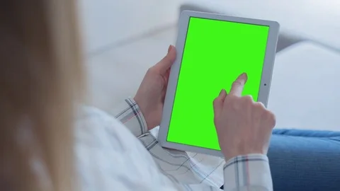 Beautiful Girl Using Tablet PC with Green Screen Laying on Sofa at Home 51 Stock Footage 75249083