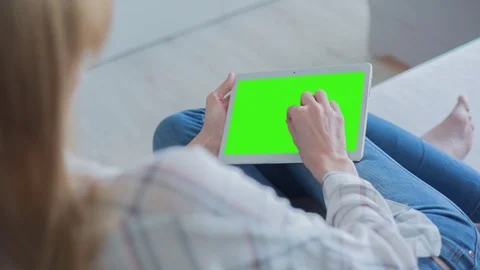 Beautiful Girl Using Tablet PC with Green Screen Laying on Sofa at Home 49 Stock Footage 75249190