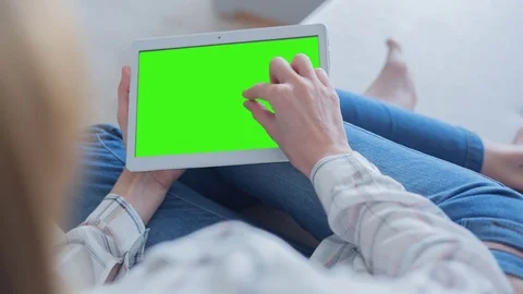 Beautiful Girl Using Tablet PC with Green Screen Laying on Sofa at Home 50 Stock Footage 75249430