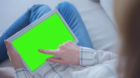 Beautiful Girl Using Tablet PC with Green Screen Laying on Sofa at Home 52 Stock Footage 75249929