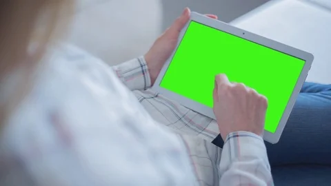 Beautiful Girl Using Tablet PC with Green Screen Laying on Sofa at Home 54 Stock Footage 75250975