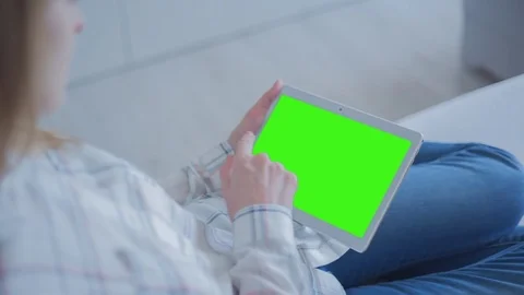 Beautiful Girl Using Tablet PC with Green Screen Laying on Sofa at Home 53 Stock Footage 75251245