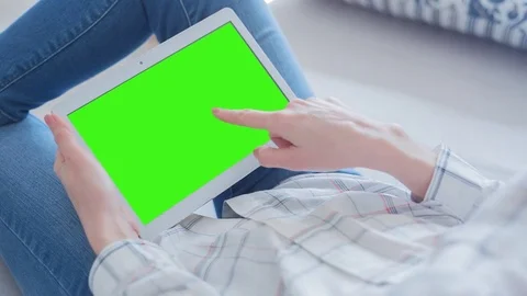 Beautiful Girl Using Tablet PC with Green Screen Laying on Sofa at Home 56 Stock Footage 75252270