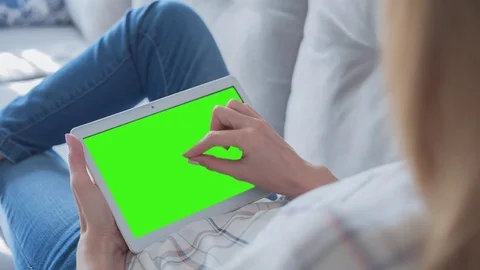 Beautiful Girl Using Tablet PC with Green Screen Laying on Sofa at Home 57 Stock Footage 75351568