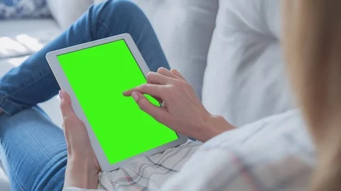 Beautiful Girl Using Tablet PC with Green Screen Laying on Sofa at Home 58 Stock Footage 75354259