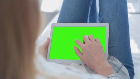 Beautiful Girl Using Tablet PC with Green Screen Laying on Sofa at Home 59 Stock Footage 75357285