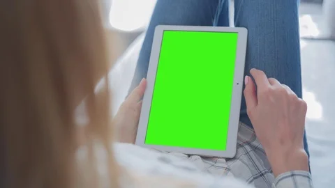 Beautiful Girl Using Tablet PC with Green Screen Laying on Sofa at Home 60 Stock Footage 75357528