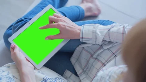 Beautiful Girl Using Tablet PC with Green Screen Laying on Sofa at Home 68 Stock Footage 75434434