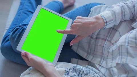 Beautiful Girl Using Tablet PC with Green Screen Laying on Sofa at Home 69 Stock Footage