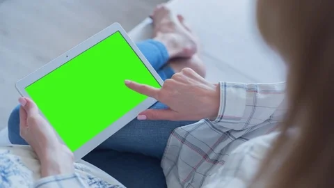 Beautiful Girl Using Tablet PC with Green Screen Laying on Sofa at Home 70 Stock Footage 75434756