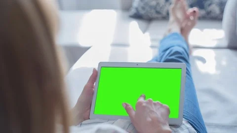 Beautiful Girl Using Tablet PC with Green Screen Laying on Sofa at Home 71 Stock Footage 75434923