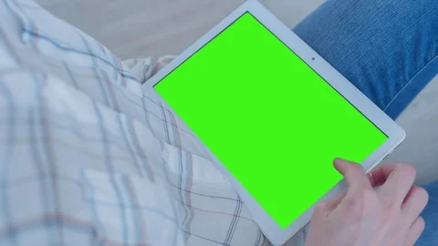 Beautiful Girl Using Tablet PC with Pre-Keyed Green Screen Sitting on the Floor Video stock 75520713