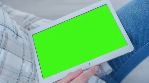 Beautiful Girl Using Tablet PC with Pre-Keyed Green Screen Sitting on the Floor Video stock 75552678