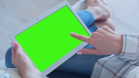 Beautiful Girl Using Tablet PC with Green Screen Laying on Sofa at Home Video stock 75559359