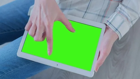 Beautiful Girl Using Tablet PC with Pre-Keyed Green Screen Sitting on the Floor Video stock 75562060
