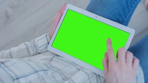 Beautiful Girl Using Tablet PC with Pre-Keyed Green Screen Sitting on the Floor Stock Footage 75569299