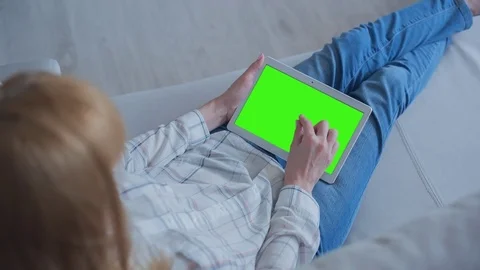 Beautiful Girl Using Tablet PC with Green Screen Laying on Sofa at Home 76 Stock Footage 75626992