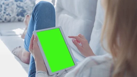 Beautiful Girl Using Tablet PC with Green Screen Laying on Sofa at Home 77 Stock Footage 75627167