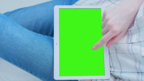 Beautiful Girl Using Tablet PC with Pre-Keyed Green Screen Sitting on the Floor Video stock 75628323