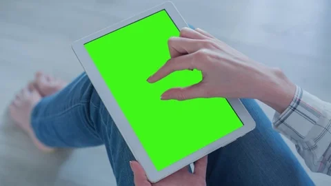 Beautiful Girl Using Tablet PC with Pre-Keyed Green Screen Sitting on the Floor Video stock 75628346
