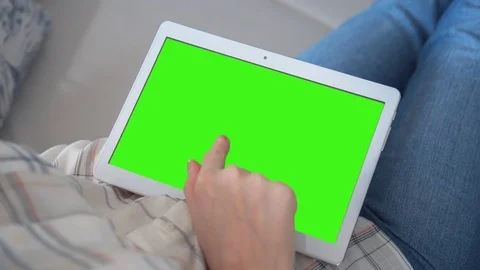 Beautiful Girl Using Tablet PC with Green Screen Laying on Sofa at Home 78 Stock Footage 79506645
