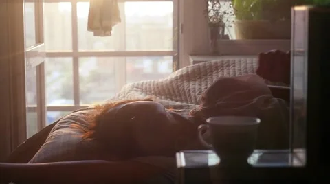 Beautiful girl wake up at her bedroom drinking tea in the morning in slowmotion Stock Footage