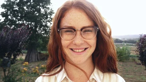 Beautiful girl woman red hair portrait smiling slow motion with glasses hipster Stock Footage