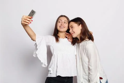 Beautiful girlfriends taking a self shot with phone. Stock Photos