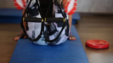 Beautiful girls learning using total body resistance exercise TRX Stock Footage 129663809