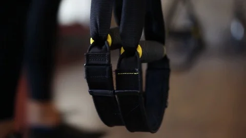 Beautiful girls learning using total body resistance exercise TRX Stock Footage 129663815