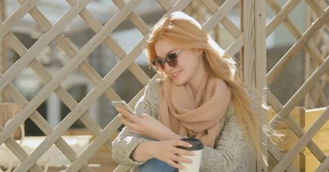 Beautiful gitl texting on smartphone in the city Stock Footage 74537208
