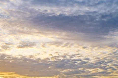 Beautiful golden sunset clouds texture background in blue evening sky Stock Photos