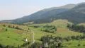 Beautiful green hills and cottage with red roof near village HD Footage