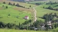 Beautiful green hills and cottage with red roof in village, Ukraine HD Footage