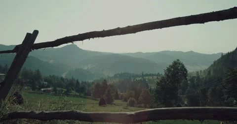 Beautiful green mountains covered with fresh green grass and old cottages Stock Footage