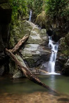 Beautiful green rainforest waterfall landscape in Tijuca Forest jungle Stock Photos