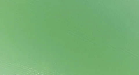 Beautiful green water reflection. Fly Shot above the sea. Video stock 68334060