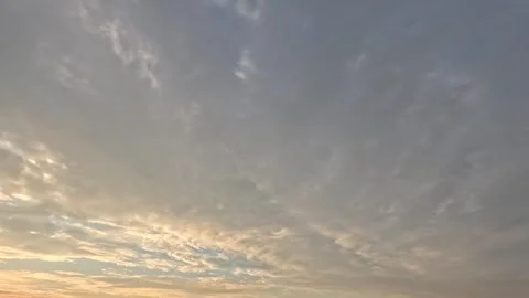 Beautiful grey and white with pink tint clouds moving fast across the sky Stock Footage 306774792