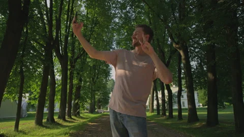 A beautiful guy is checked out and makes selfies on the phone Stock Footage 157404904