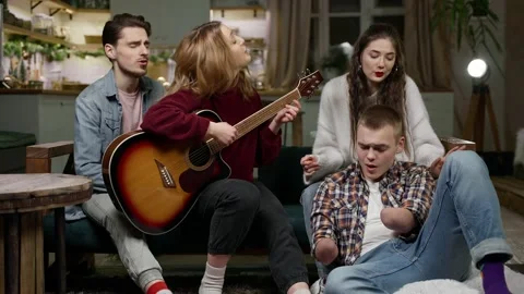 Beautiful guy with disability with two amputated stump hands in company friends Stock Footage 167751696