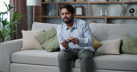 Beautiful guy in his 30s playing online video games at home. Stock Footage 243525185