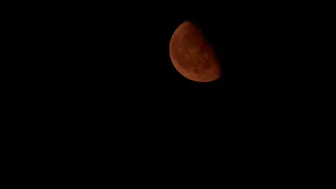 Beautiful half red moon close-up on a black sky. Close-up moon and craters Stock Footage 124703546