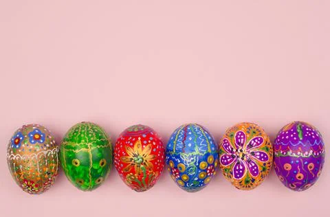 Beautiful hand-painted Easter eggs on a light pink background Stock Photos