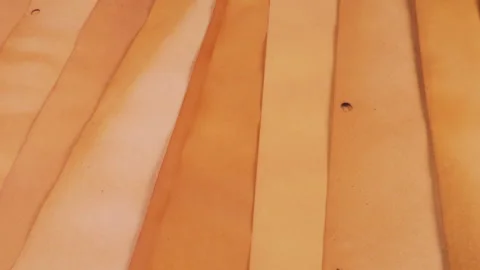 Beautiful handmade paper sheets in warm yellow, orange, and tan beige shades. 動画素材 329726533