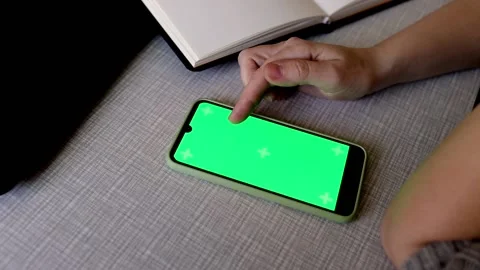 Beautiful hands of a girl leaf through the tape on the phone against. Stock Footage 193080606