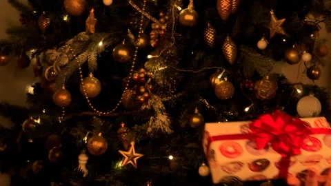 Beautiful hands give a gift on the background of the Christmas tree. Paper 動画素材 120134072