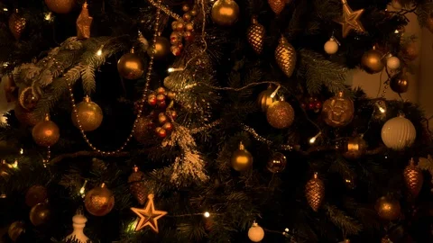 Beautiful hands give a gift on the background of the Christmas tree. Gold  gift  動画素材 120134084