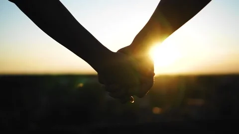Beautiful hands of lovers at sunset in the evening. Close up Stock Footage