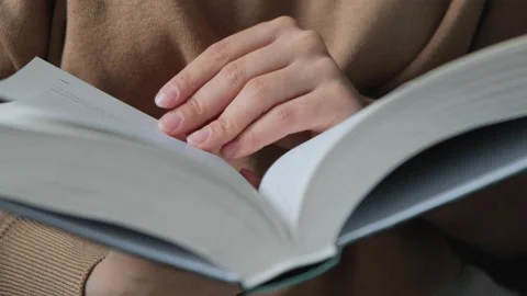 Beautiful hands young model turning pages of the book Stock Footage 134944725